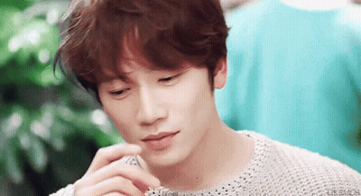 Young Man's Face With Hand GIF
