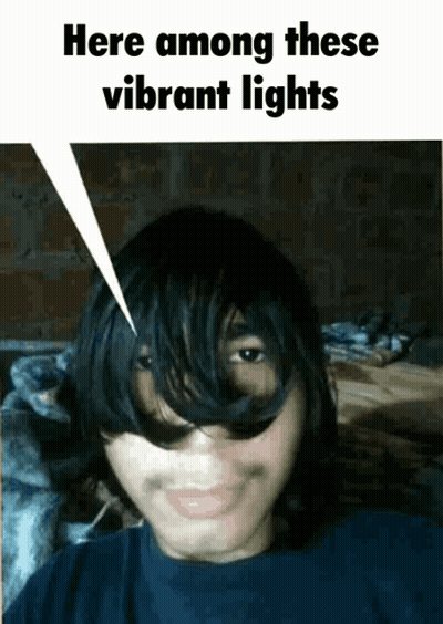 Young Man Saying Here Among Vibrant Lights GIF