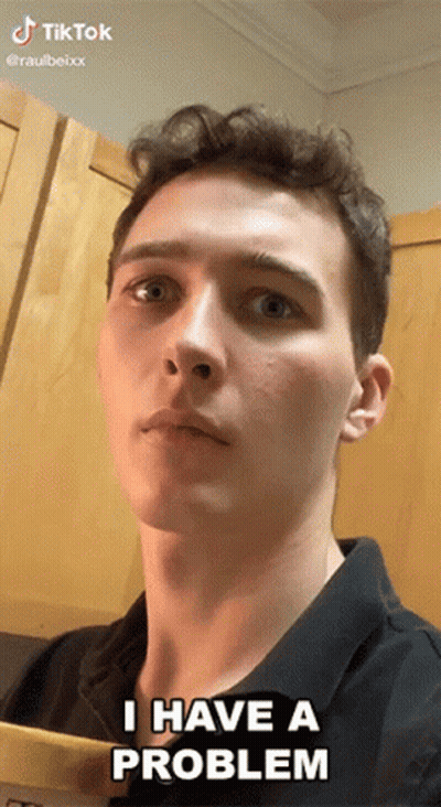 Young Man Says I Have A Problem In Front Of Wooden Cabinet GIF