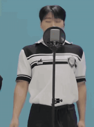 Young Man Singing Into Microphone In Black And White Shirt GIF