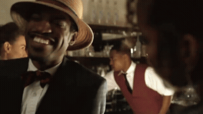 Young Man Singing Into Microphone On Stage With NBC Logo GIF