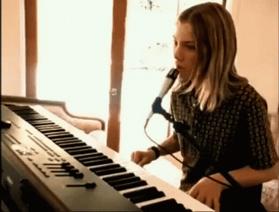 Young Man Singing Into Microphone Playing Keyboard GIF
