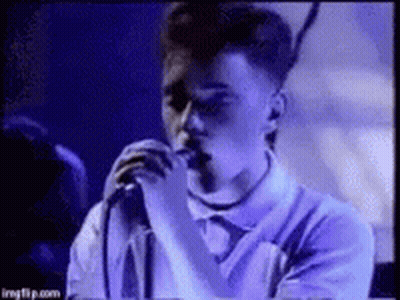 Young Man Singing Into Microphone Purple Shirt GIF