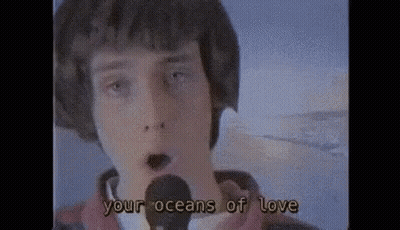 Young Man Singing Into Microphone Your Oceans Of Love GIF