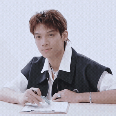 Young Man Sitting At Desk With Clipboard GIF