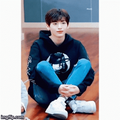 Young Man Sitting Cross-Legged GIF