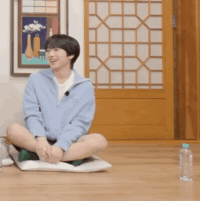 Young Man Sitting Crossed Legs With Water Bottle GIF
