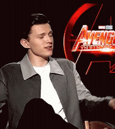 Young Man Sitting In Front Of Avengers Age Of Ultron Sign GIF
