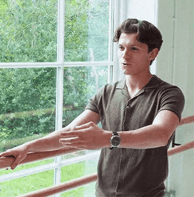 Young Man Sitting In Front Of Avengers Age Of Ultron Sign GIF