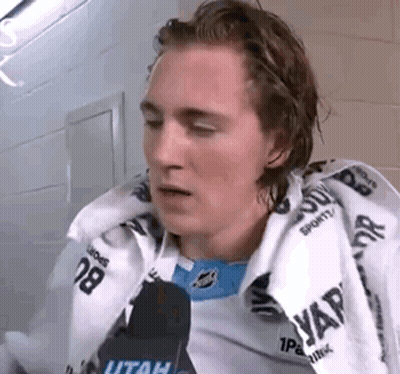 Young Man Sitting In Locker Room With Towel And Microphone GIF
