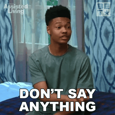 Young Man Sitting On Bed Saying Don't Say Anything GIF