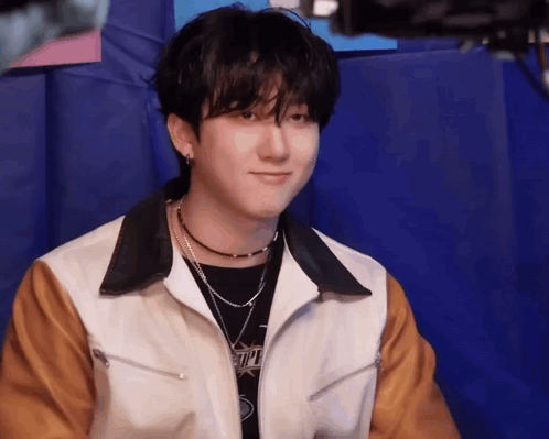 Young Man Sitting On Blue Cushion GIF