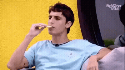 Young Man Sitting On Couch Eating Food GIF