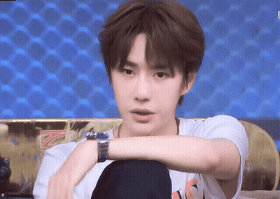 Young Man Sitting On Couch With Skateboard And Watch GIF