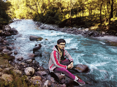 Young Man Sitting On Rock By River GIF