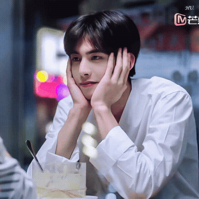 Young Man Sitting With Hand On Face GIF