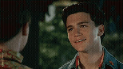 Young Man Smiling At Friend In Floral Shirt GIF