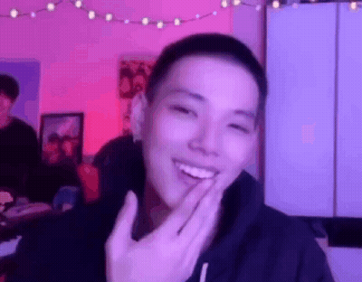 Young Man Smiling Covering Mouth GIF