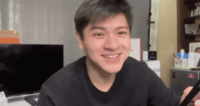 Young Man Smiling Holding Cell Phone GIF