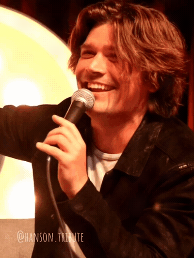 Young Man Smiling Holding Microphone @Hanson Tribute GIF