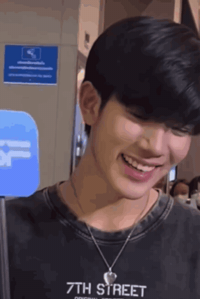 Young Man Smiling In Black 7Th Street Shirt GIF