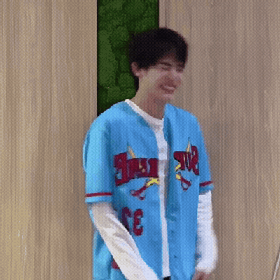 Young Man Smiling In Blue Baseball Jersey GIF