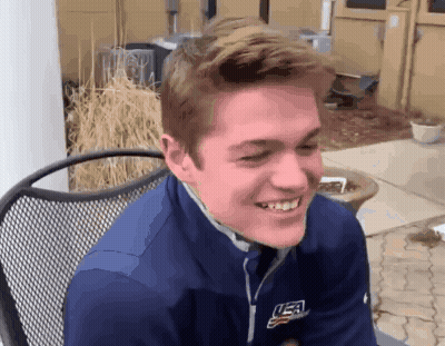 Young Man Smiling In Blue USA Jacket GIF