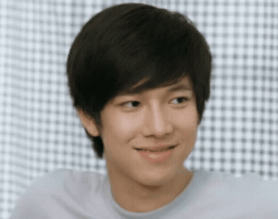 Young Man Smiling In Front Of Checkered Wall GIF