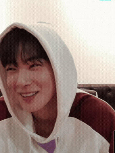 Young Man Smiling In Hooded Sweatshirt GIF