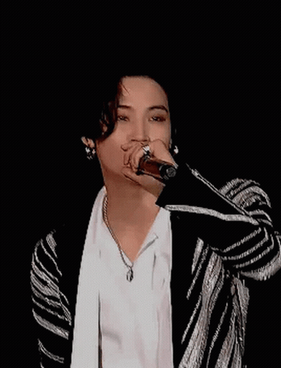 Young Man Smiling In White Shirt And Black-And-White Jacket GIF