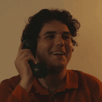 Young Man Smiling On Phone GIF