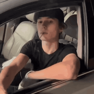 Young Man Smoking Cigarette In Car GIF
