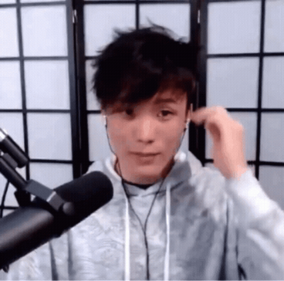 Young Man Standing At Microphone With Headphones GIF