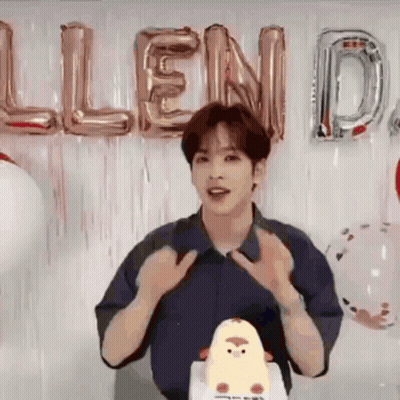 Young Man Standing Before Cake And Balloons GIF