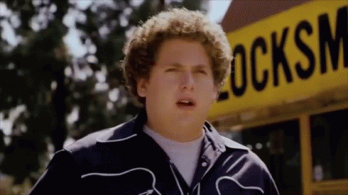 Young Man Standing In Front Of Yellow School Bus GIF