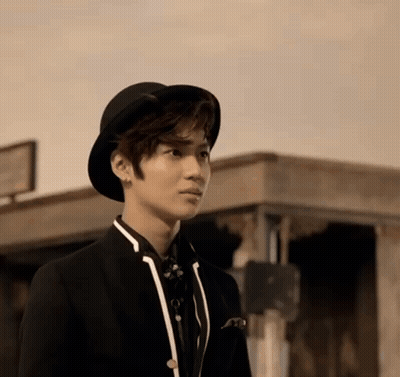Young Man Standing In Hat And Suit GIF