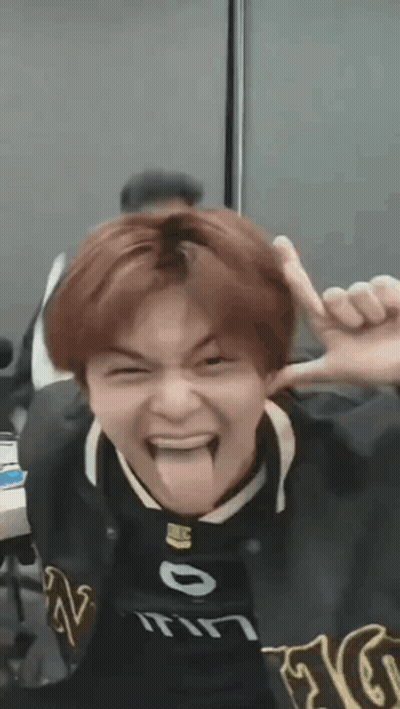 Young Man Sticking Tongue Out In Black Jacket GIF