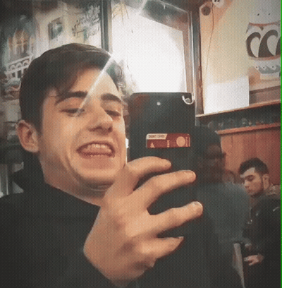 Young Man Taking Selfie With Coca Cola Sign GIF
