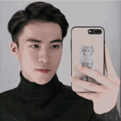 Young Man Taking Selfie With Kaws Bear Phone GIF