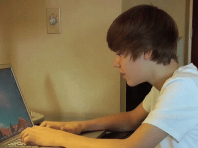 Young Man Typing On Laptop GIF