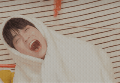 Young Man Under Blanket With Mouth Open GIF