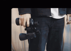 Young Man Using High Resolution Binoculars GIF