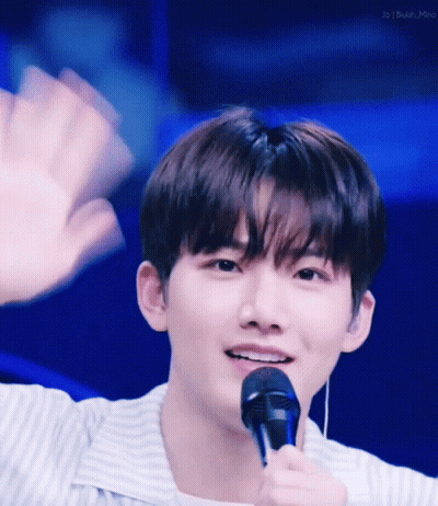 Young Man Waving And Smiling With Microphone GIF