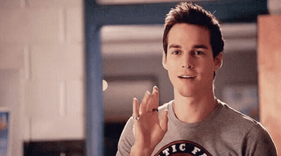 Young Man Waving In Kitchen GIF