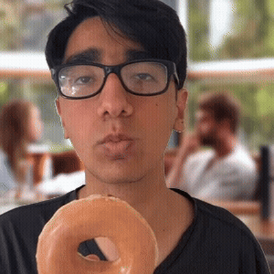 Young Man Wearing Glasses Holding Donut GIF