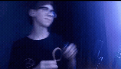 Young Man Wearing Glasses Holding Scissors GIF