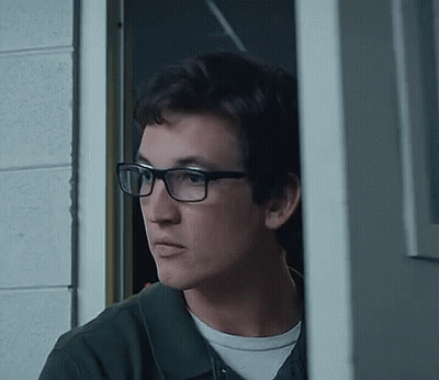 Young Man Wearing Glasses Standing In Doorway GIF