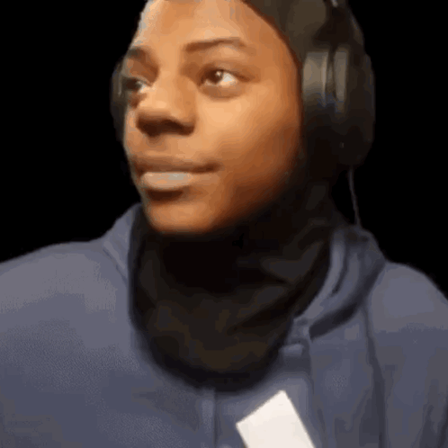 Young Man Wearing Headphones And Blue Hoodie Looking At Camera GIF