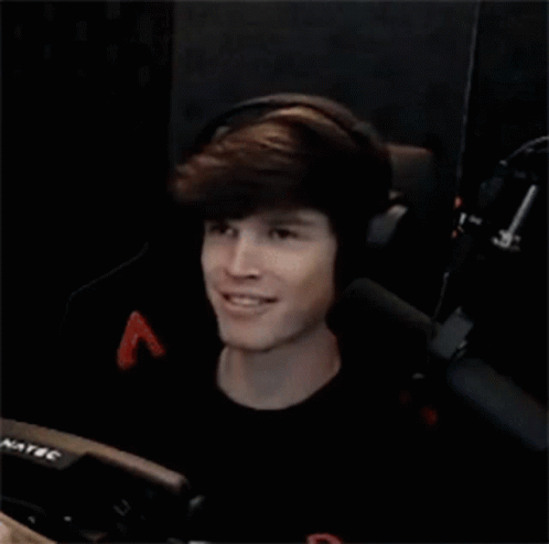 Young Man Wearing Headphones And Smiling In Chair GIF