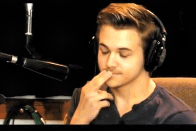 Young Man Wearing Headphones Covering Mouth